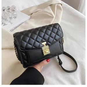 Detail of black quilted leather shoulder bag with gold perfume bottle twist lock