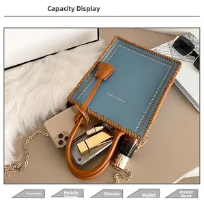 Detail showing internal capacity of blue tote bag with phone, wallet and cosmetics