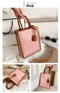 Pink structured tote bag featuring brown contrast stitching and golden chain strap