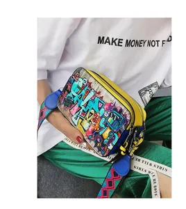 Detail of graffiti print camera bag with vibrant colors and adjustable wide strap
