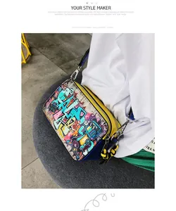 Detail of graffiti camera bag showing colorful urban prints and wide stylish shoulder strap