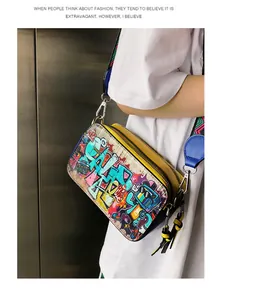 Detail of vibrant graffiti camera bag with colorful wide strap and yellow double zippers