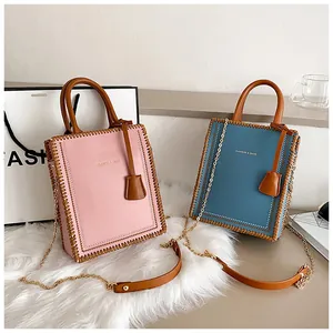 Detail of pink and blue DIY tote bags with handcrafted stitching and chain straps