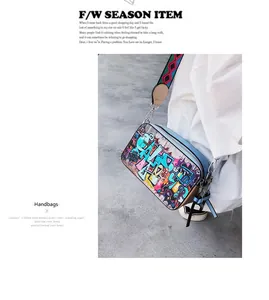Detail of colorful graffiti art crossbody bag with wide geometric woven shoulder strap