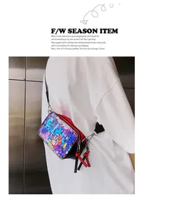 Detail of crossbody camera bag with colorful graffiti print and adjustable strap