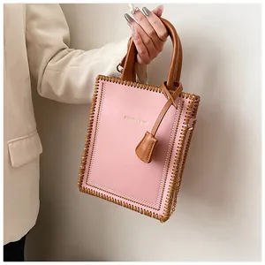 Detail of pink leather tote bag with brown woven edges and stylish fashion tag