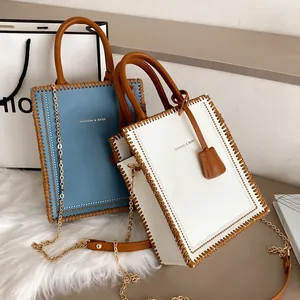 Chic tote bag set in blue and white with brown woven edges and gold chain strap