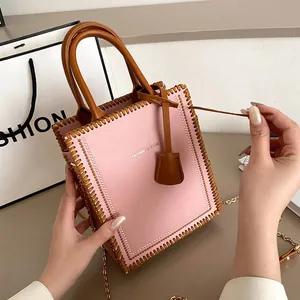 Pink and brown tote bag with pearl trim, woven edges and a gold chain strap