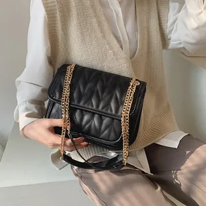Chic black quilted crossbody bag with golden chain strap and V-pattern stitching