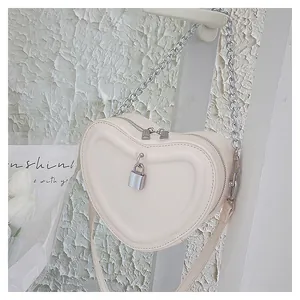 Chic heart-shaped crossbody bag for girls featuring quilted texture and silver chain strap