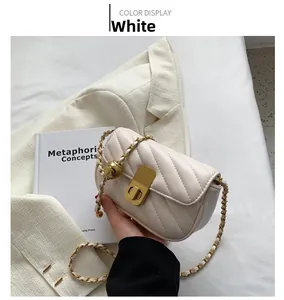 Détail du sac bandoulière blanc matelassé avec chaîne dorée et fermoir en métal doré