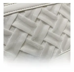 Close-up of white woven leather texture on a fashion handbag showing detail of the material