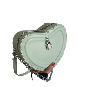 Quilted heart-shaped mini shoulder bag in mint green with silver chain and lock charm