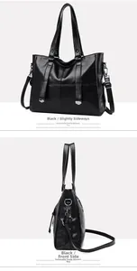 Detail view of the black tote bag showing silver metal accents and dual straps