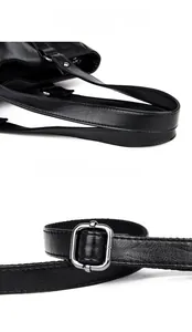 Detail of black leather handbag featuring dual handles and adjustable silver metal buckle