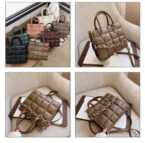 Detailed view of coffee brown quilted handbag featuring thick chain and adjustable strap
