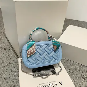 Fashionable light blue woven handbag for women with silk scarf handle and silver chain strap