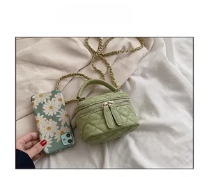 Mini quilted leather crossbody bag in sage green with chain strap and top handle