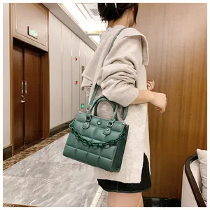 Deep green small square bag with textured rhombic pattern and chunky acrylic chain