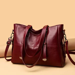 Deep wine red large capacity tote bag in glossy leather with adjustable shoulder strap