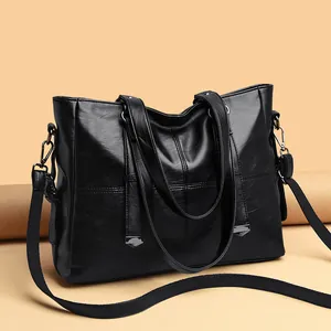 Vintage black faux leather tote bag with dual handles and adjustable shoulder strap