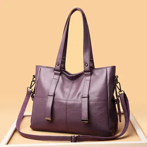 Chic burgundy faux leather tote bag with gold metal accents and adjustable shoulder strap