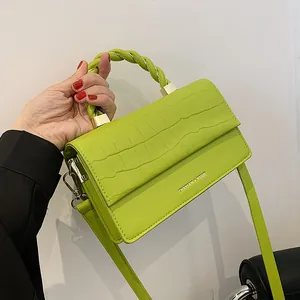 Lime green crocodile pattern small square handbag with twisted handle and gold hardware