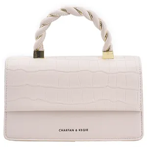 Beige faux crocodile skin handbag with stylish braided handle and gold hardware detail
