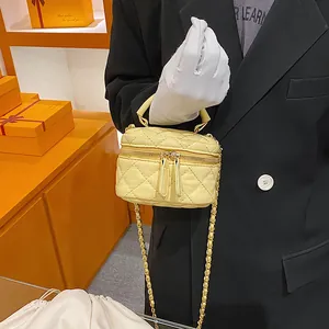 Chic yellow quilted mini vanity case bag with leather chain strap and top handle