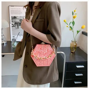 Detail van roze marmeren zeshoekige crossbodytas met parelsluiting en grove ketting