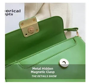 Detail of green faux leather handbag featuring a golden magnetic clasp and textured finish