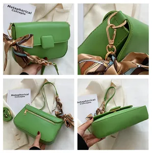 Detail view of green PU leather shoulder bag showing gold hardware and silk scarf handle