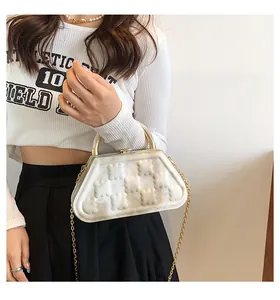 Detail of white marble texture trapezoid bag with embossed bears and gold metal handle
