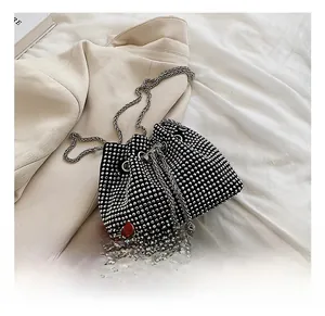 Close-up of black drawstring bucket bag with sparkling silver rhinestones and chain