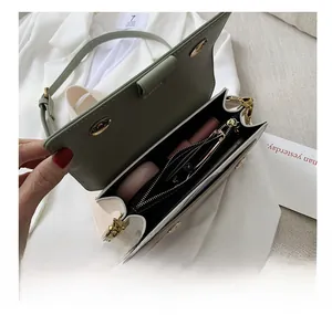 Detail showing internal compartments of the crossbody bag with practical storage space