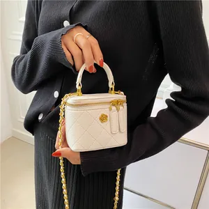 White quilted mini box bag with gold chain strap and camellia metal decoration