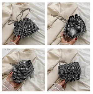 Macro shot of black rhinestone bucket bag with sparkling silver crystals and pearl drawstring