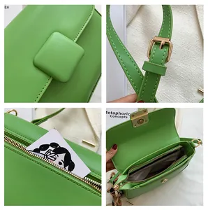 Detail view of green leather bag hardware, inner compartments and back zipper pocket