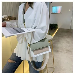 Fashion cross-body bag for women with color-blocking panels and wide fabric strap in casual setting
