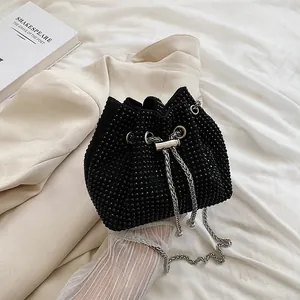 Fashionable black rhinestone bucket bag with silver chain strap for elegant evening wear