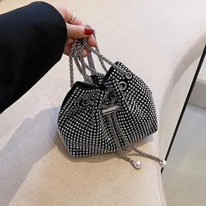 Elegant black rhinestone bucket bag with silver chain and pearl drawstring details