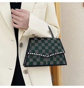 Dettaglio della borsa a scacchi con strass con catena argentata e manico elegante