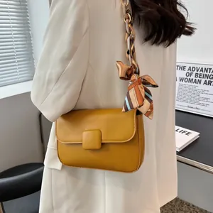 Fashionable mustard yellow leather shoulder bag with silk scarf resin chain strap