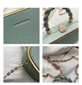 Detail view of woven handle and gold hardware on green litchi texture box bag