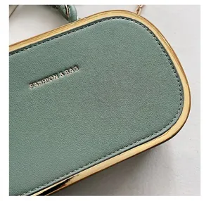 Macro detail of litchi textured leather bag with gold frame and fashion text logo