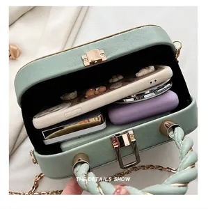 Interior view showing capacity of mint green leather box bag with accessories