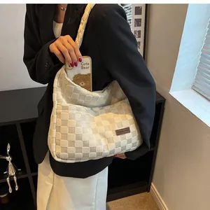 Detail of cream checkerboard underarm bag with side pocket for smartphone storage