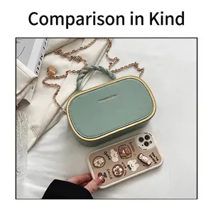 Size comparison of mint green box bag next to a smartphone showing compact dimensions