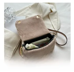 Capacité interne du sac bandoulière en peluche avec objets sur blazer blanc