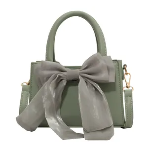 Sage green PU leather handbag with oversized organza bow and crossbody strap